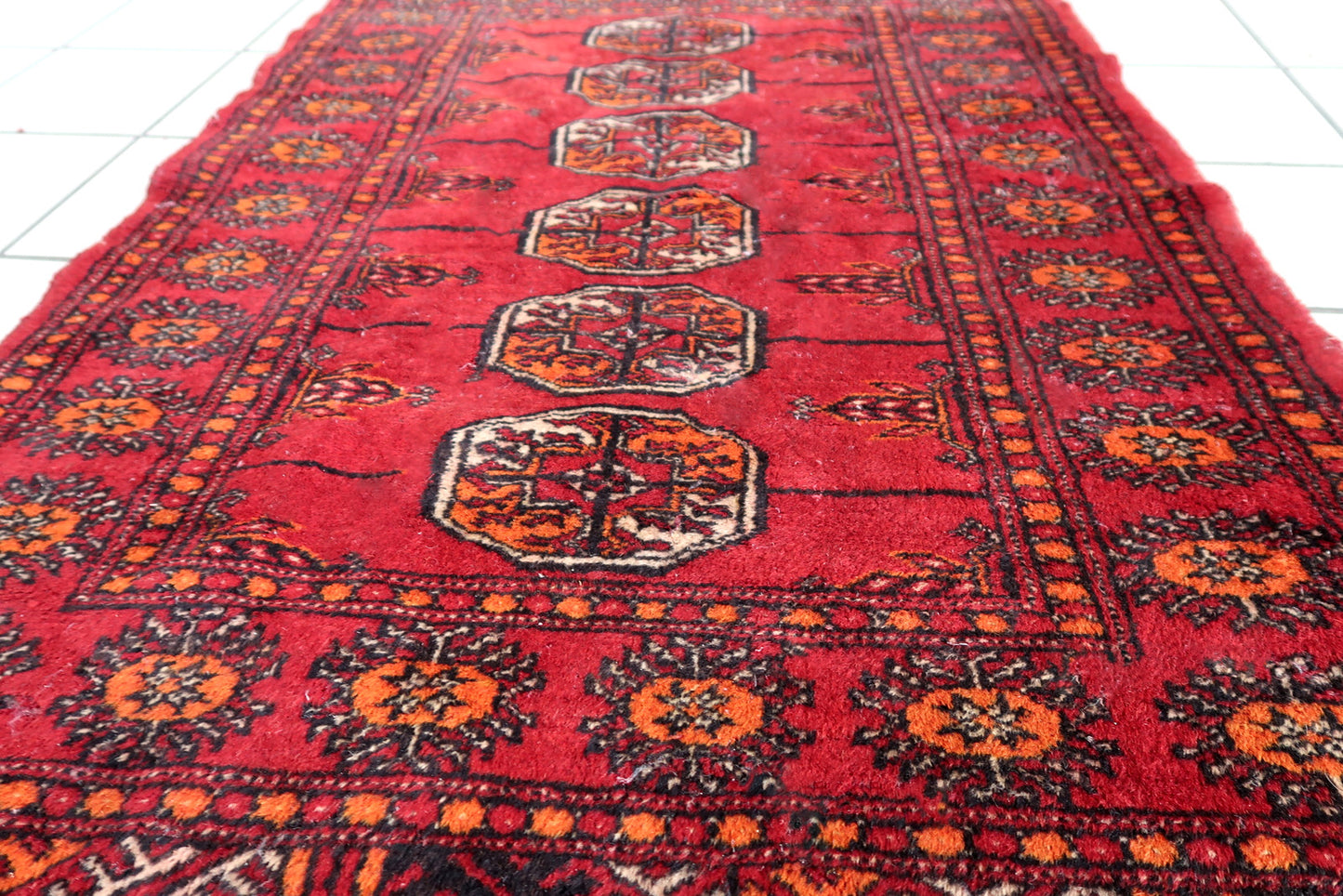 Handmade vintage Pakistani Lahore rug in bright red color. The rug is from the end of 20th century in original condition, it has some low pile. The rug made in traditional design. The rug is thin.