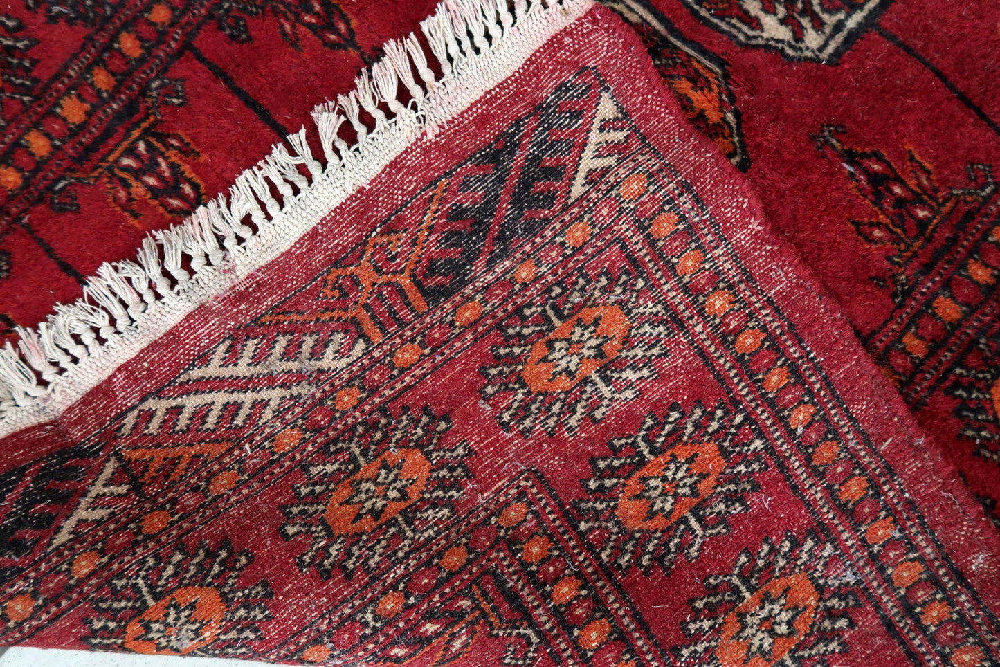 Handmade vintage Pakistani Lahore rug in bright red color. The rug is from the end of 20th century in original condition, it has some low pile. The rug made in traditional design. The rug is thin.