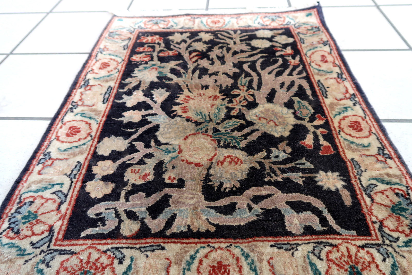 Handmade vintage Persian Tabriz rug in black color and garden design. The rug is from the end of 20th century in original good condition.