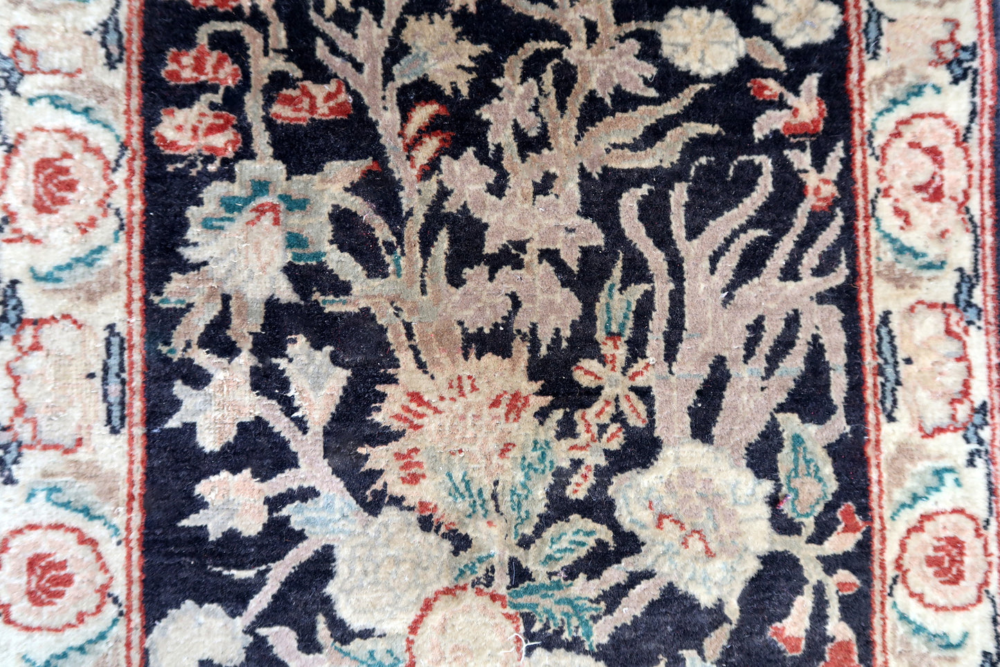 Handmade vintage Persian Tabriz rug in black color and garden design. The rug is from the end of 20th century in original good condition.