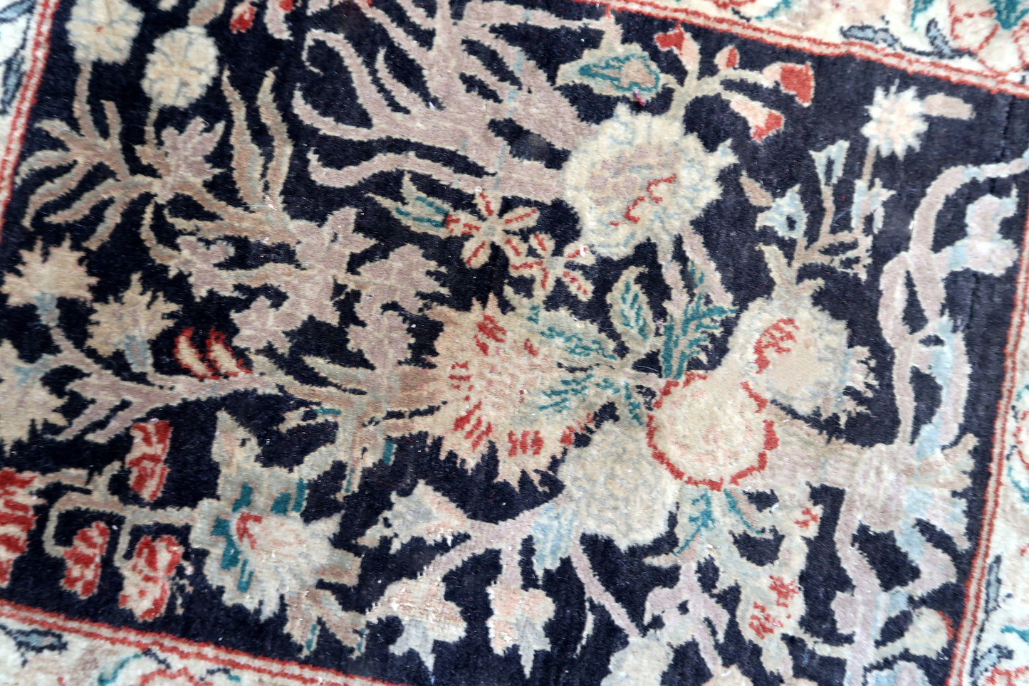 Handmade vintage Persian Tabriz rug in black color and garden design. The rug is from the end of 20th century in original good condition.