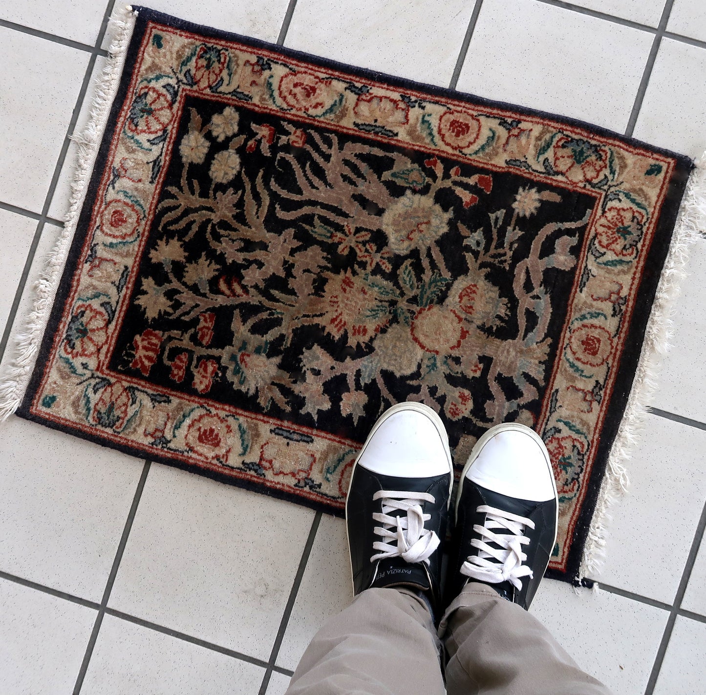Handmade vintage Persian Tabriz rug in black color and garden design. The rug is from the end of 20th century in original good condition.