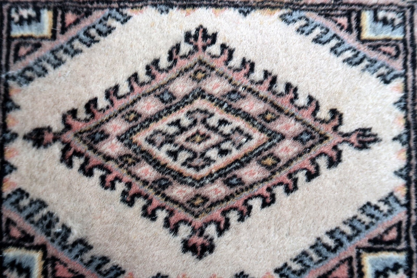Handmade vintage Uzbek Bukhara rug in traditional design. The rug is from the end of 20th century in original good condition.