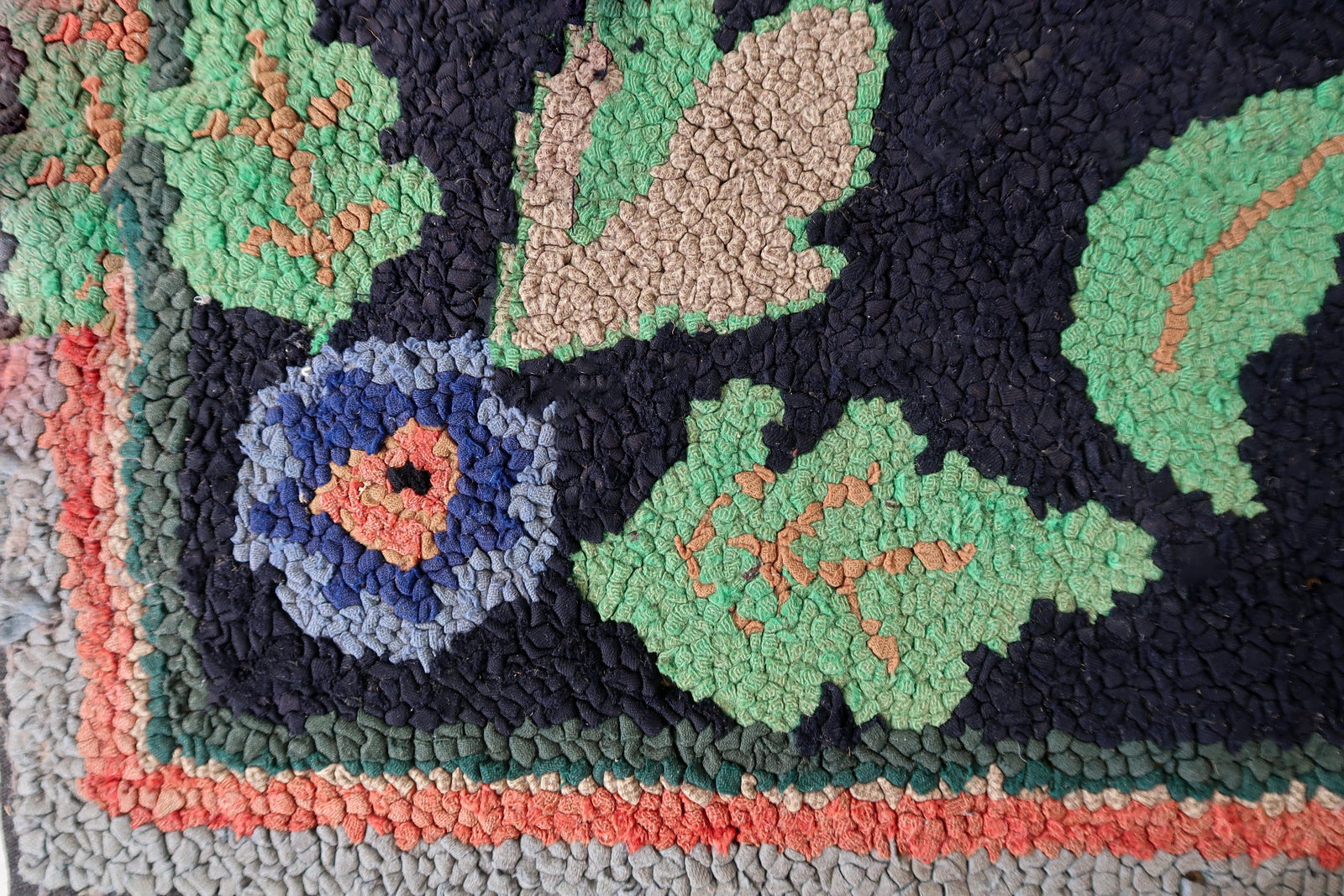 Handmade antique American Hooked rug in floral design and black background. The rug is from the beginning of 20th century. It is in good condition, has some old restorations. 
