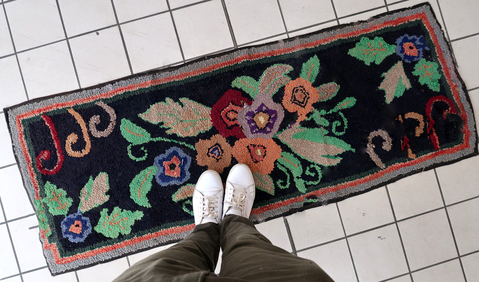 Handmade antique American Hooked rug in floral design and black background. The rug is from the beginning of 20th century. It is in good condition, has some old restorations. 