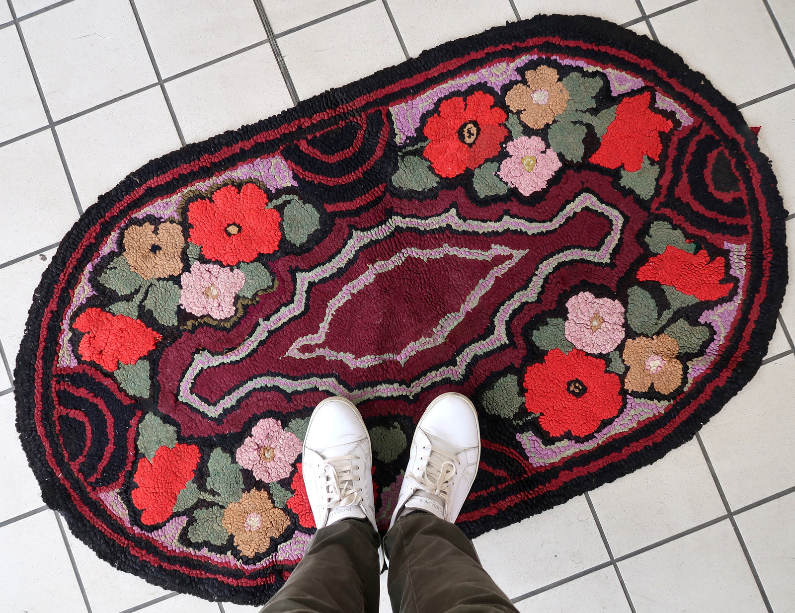 Handmade antique American Hooked rug in floral design and black background. The rug is from the beginning of 20th century. It is in good condition, has some old restorations. 