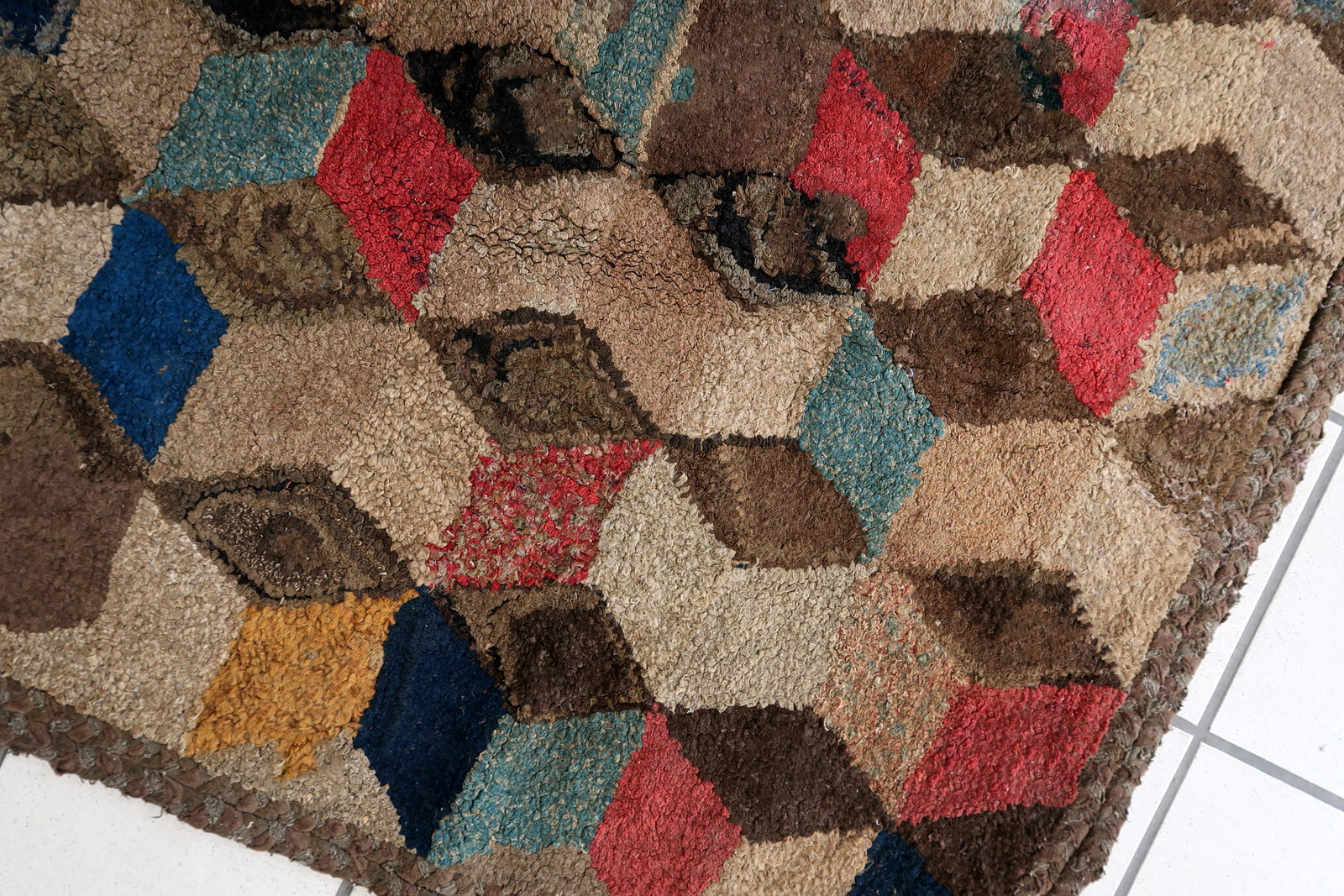 Handmade antique American Hooked rug in geometric design. The rug is from the end of 19th century. The rug has some old restorations. 