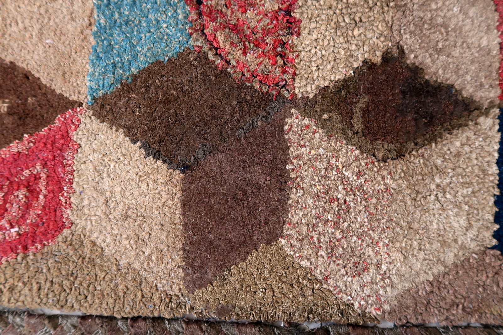 Handmade antique American Hooked rug in geometric design. The rug is from the end of 19th century. The rug has some old restorations. 