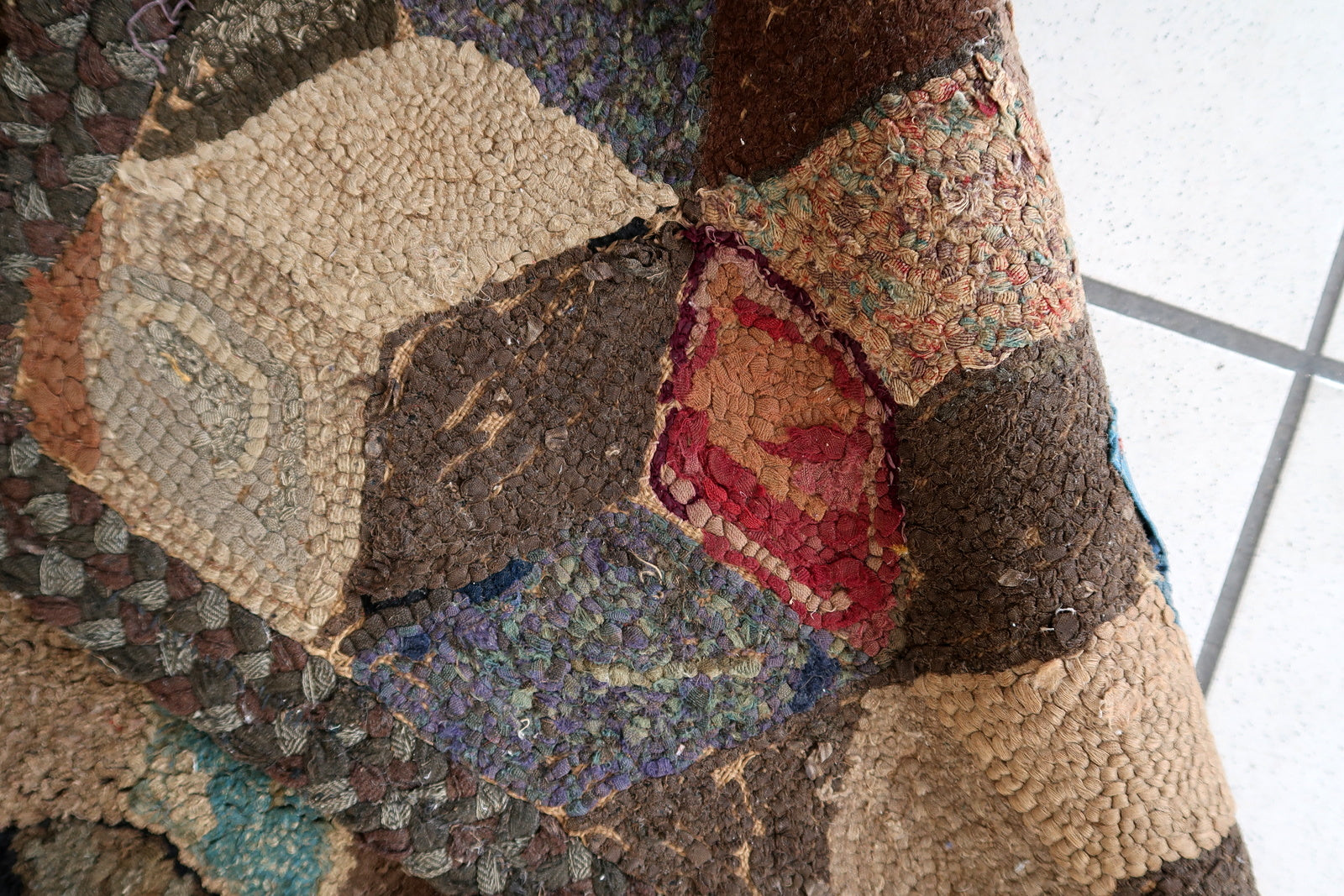 Handmade antique American Hooked rug in geometric design. The rug is from the end of 19th century. The rug has some old restorations. 