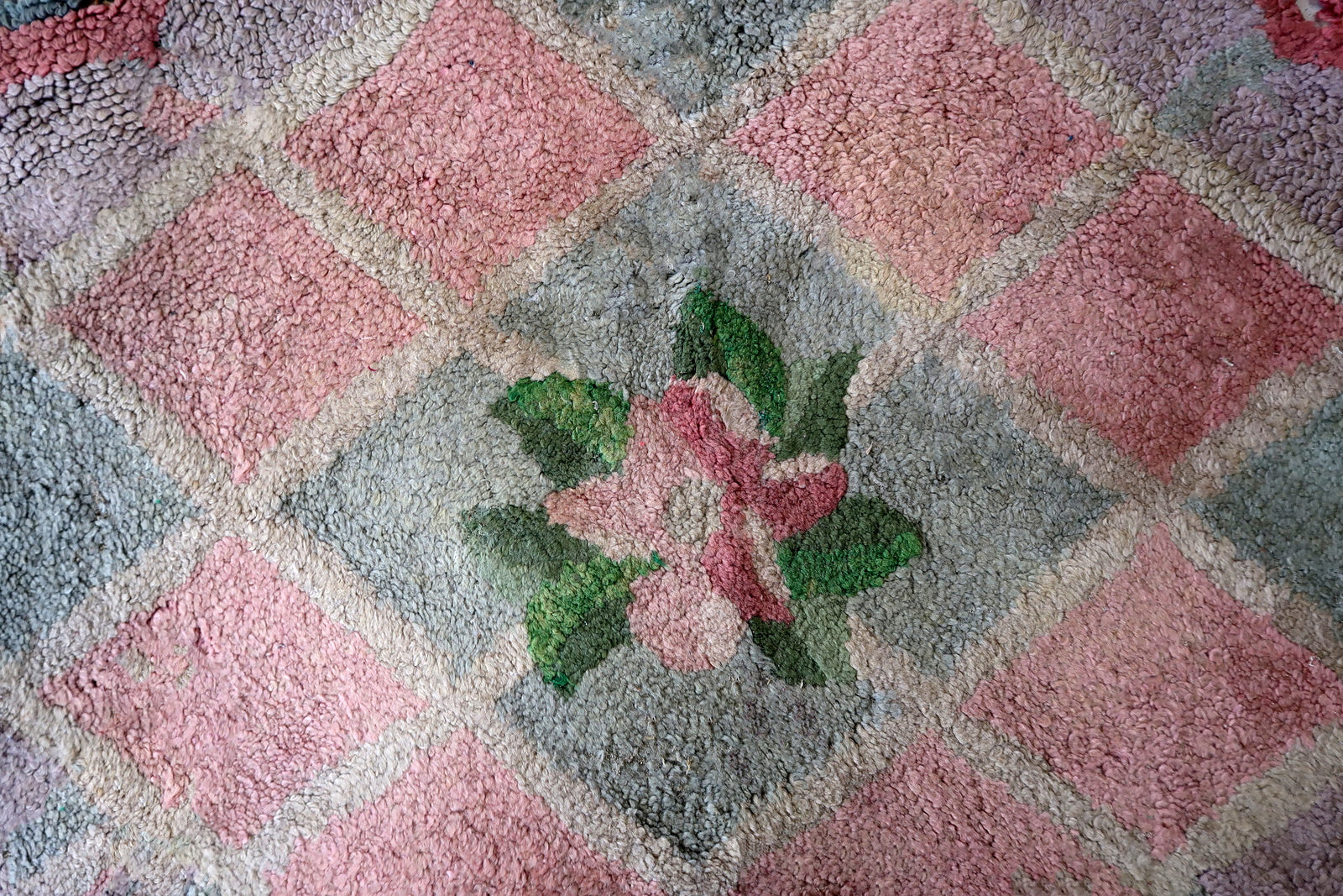 Handmade vintage American Hooked rug in unusual design and pastel shades. The rug is from the end of 20th century. It has some old restorations.