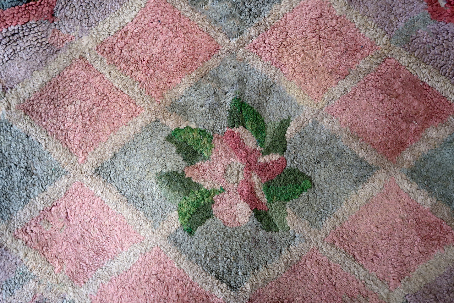 Handmade vintage American Hooked rug in unusual design and pastel shades. The rug is from the end of 20th century. It has some old restorations.