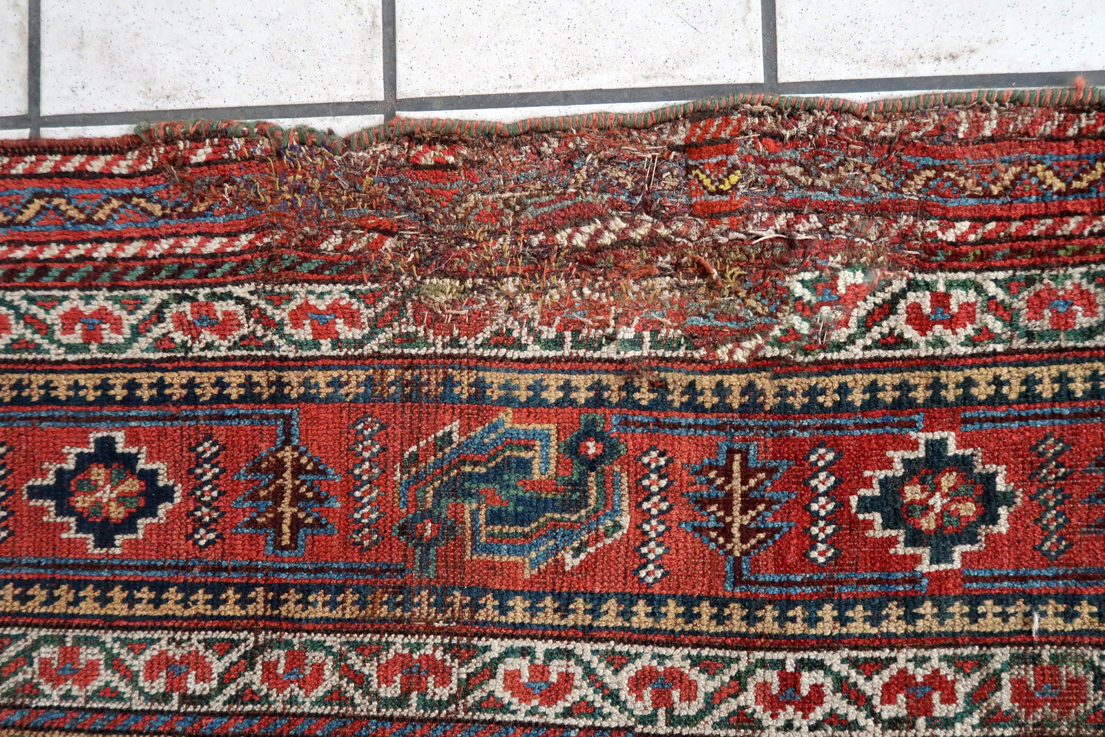 Handmade antique oversized Persian Khamseh rug in traditional design. The rug is from the end of 19th century in distressed condition. 