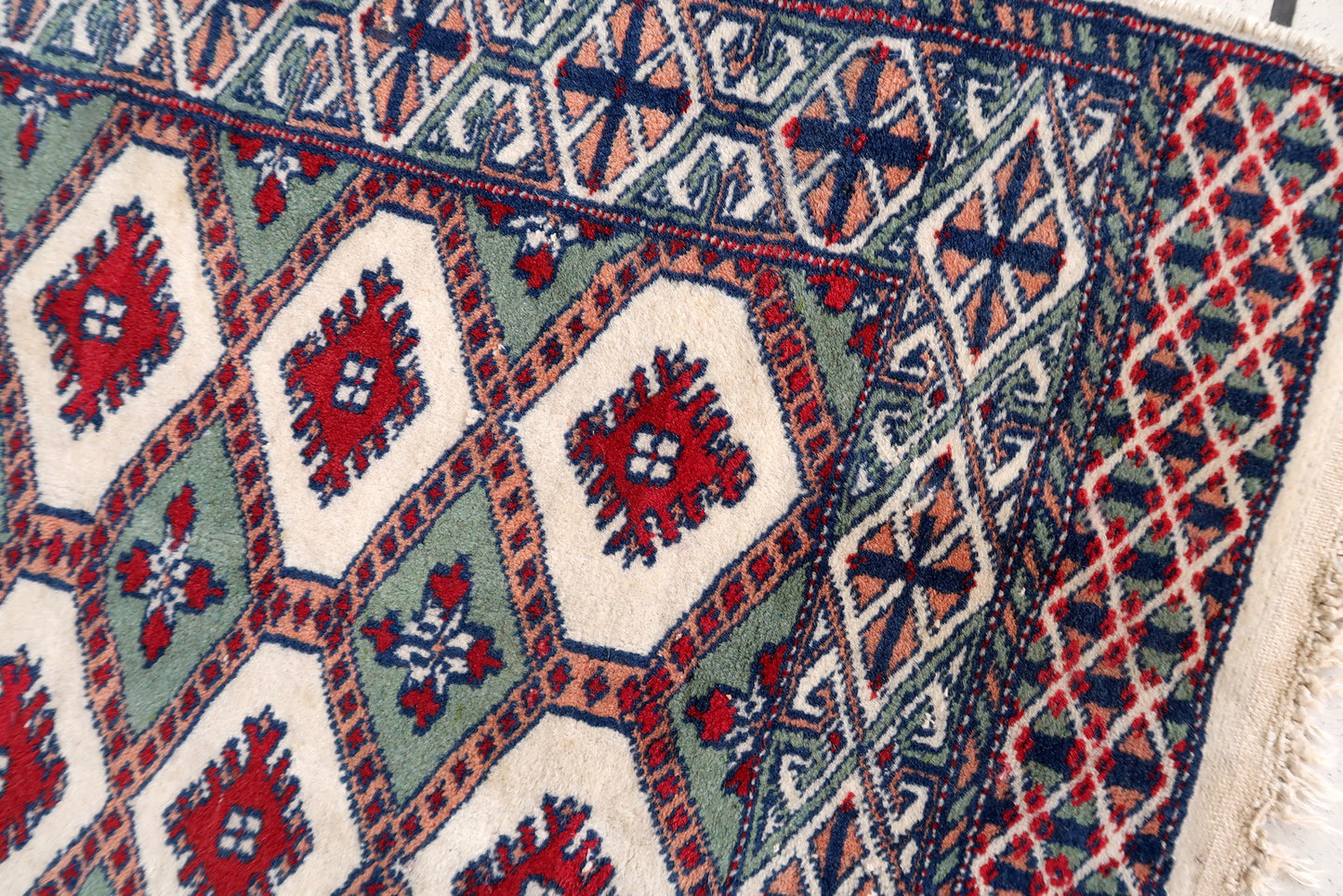Handmade vintage Bukhara rug in unusual colors. The rug is in original good condition, it is from the end of 20th century.