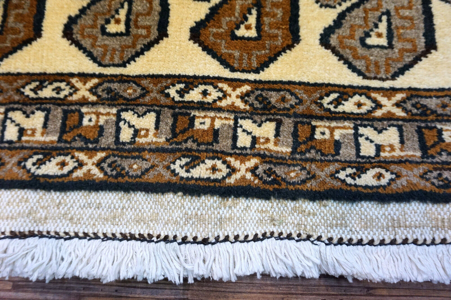 Handmade vintage Persian Gabbeh rug in beige color with repeating paisley design. The rug is from the end of 20th century in original good condition.