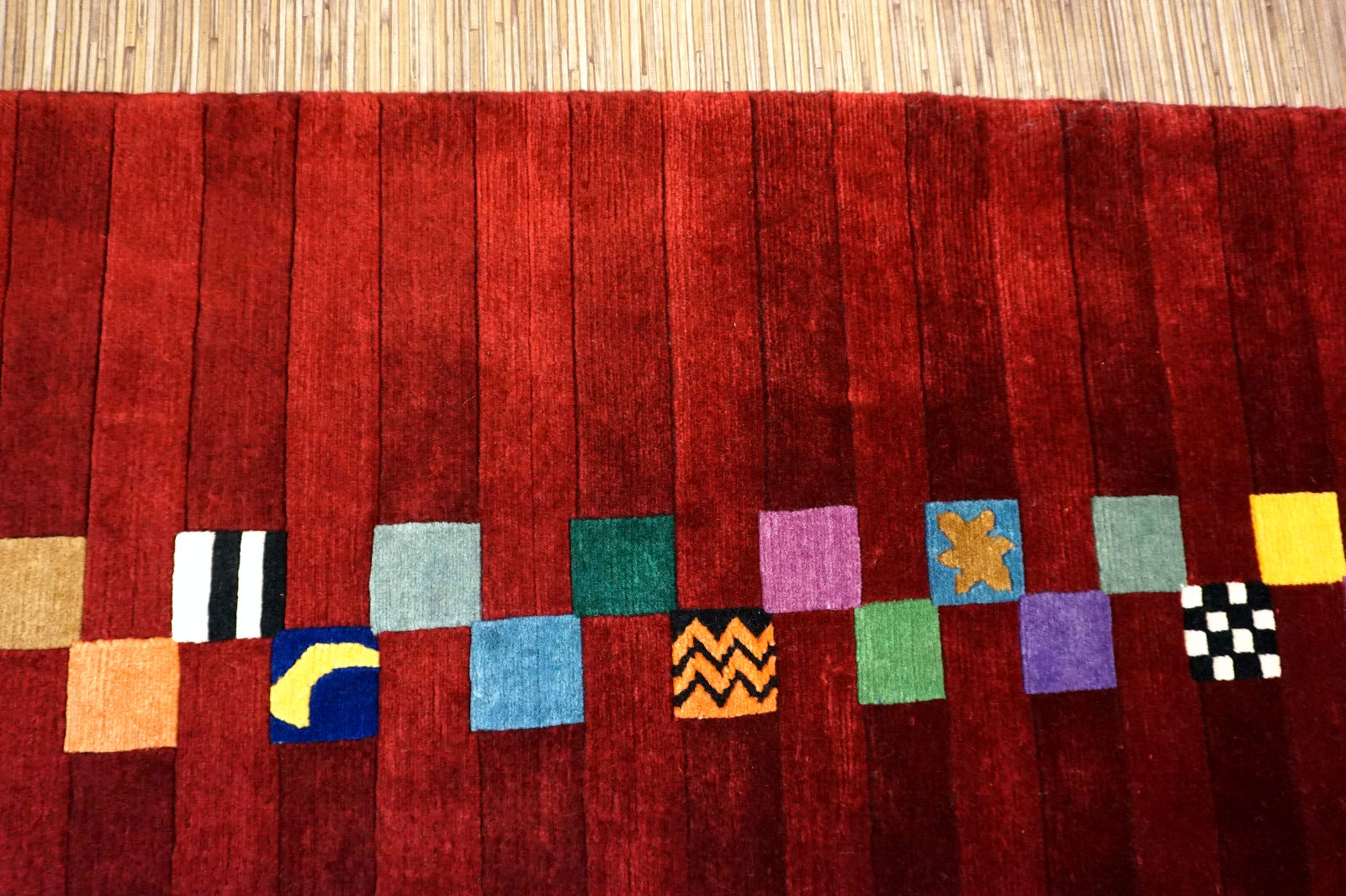 Handmade vintage Persian Gabbeh rug in bright red color and colorful geometric design. The rug is from the end of 20th century in original good condition.