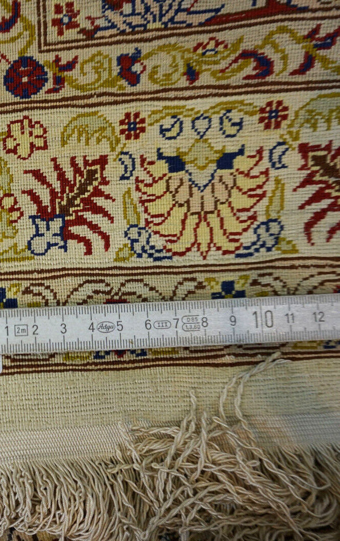 Handmade vintage Turkish Hereke rug made in natural silk. The rug is from the end of 20th century in original good condition.