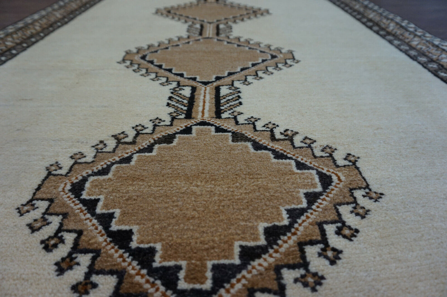 Handmade vintage Persian Gabbeh rug in beige color and repeating geometric design. The rug is from the end of 20th century in original good condition.