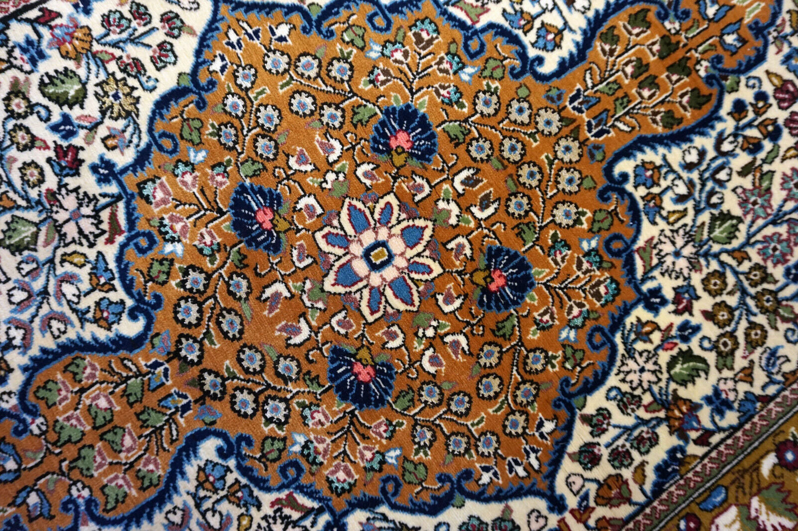 Handmade vintage Persian Qum rug in traditional medallion design. The rug is from the end of 20th century in original good condition.