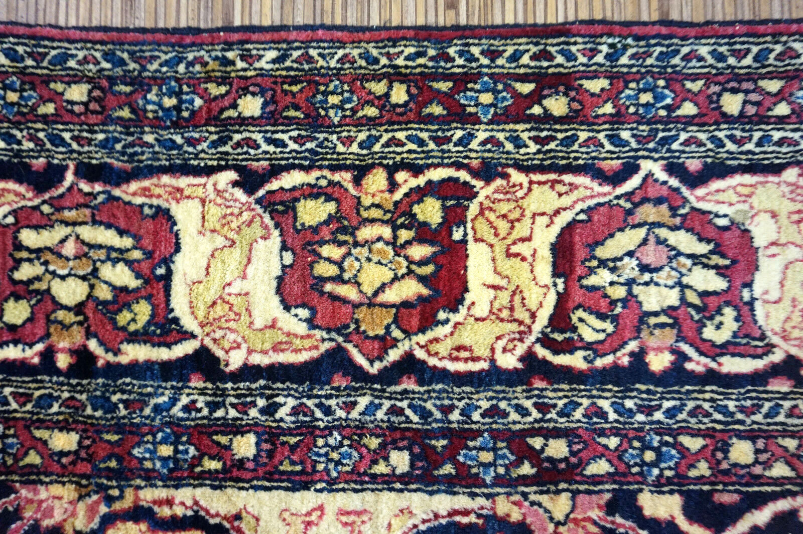 Handmade antique Persian Isfahan rug in unusual repeating design. The rug is from the beginning of 20th century in original good condition. It is made in wool.