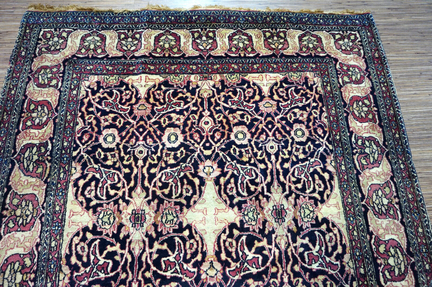 Handmade antique Persian Isfahan rug in unusual repeating design. The rug is from the beginning of 20th century in original good condition. It is made in wool.