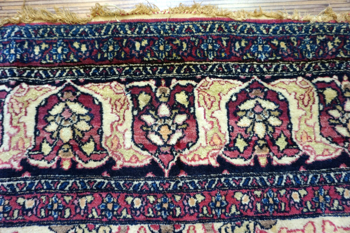 Handmade antique Persian Isfahan rug in unusual repeating design. The rug is from the beginning of 20th century in original good condition. It is made in wool.