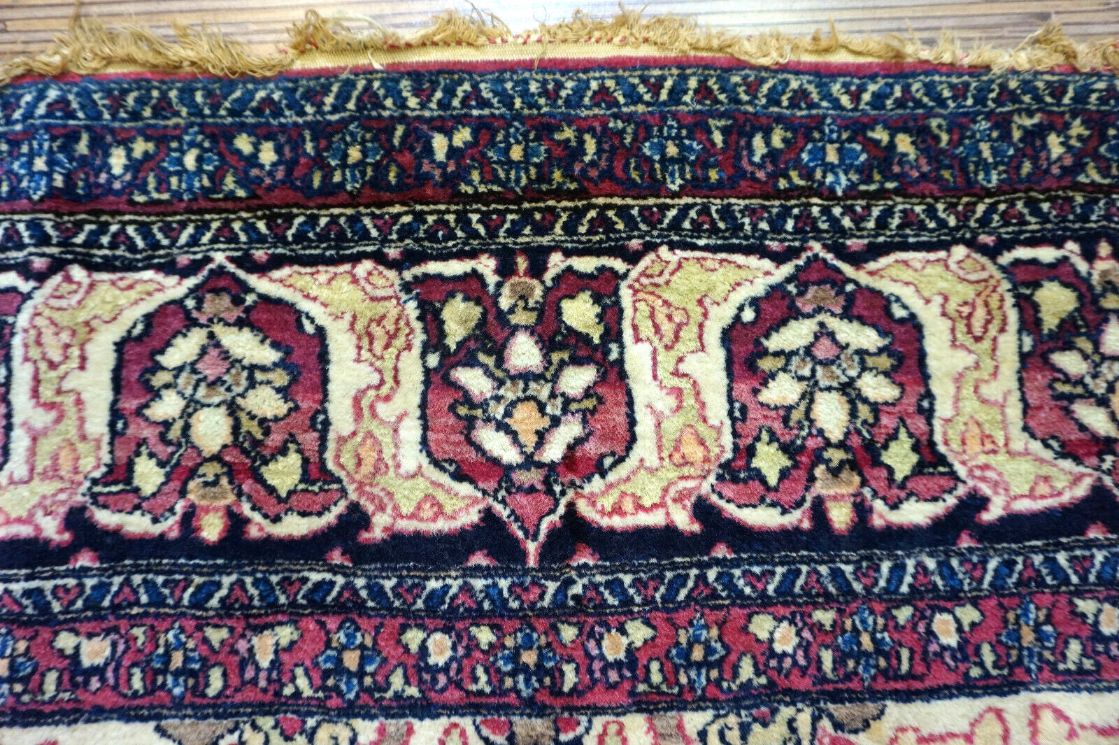 Handmade antique Persian Isfahan rug in unusual repeating design. The rug is from the beginning of 20th century in original good condition. It is made in wool.