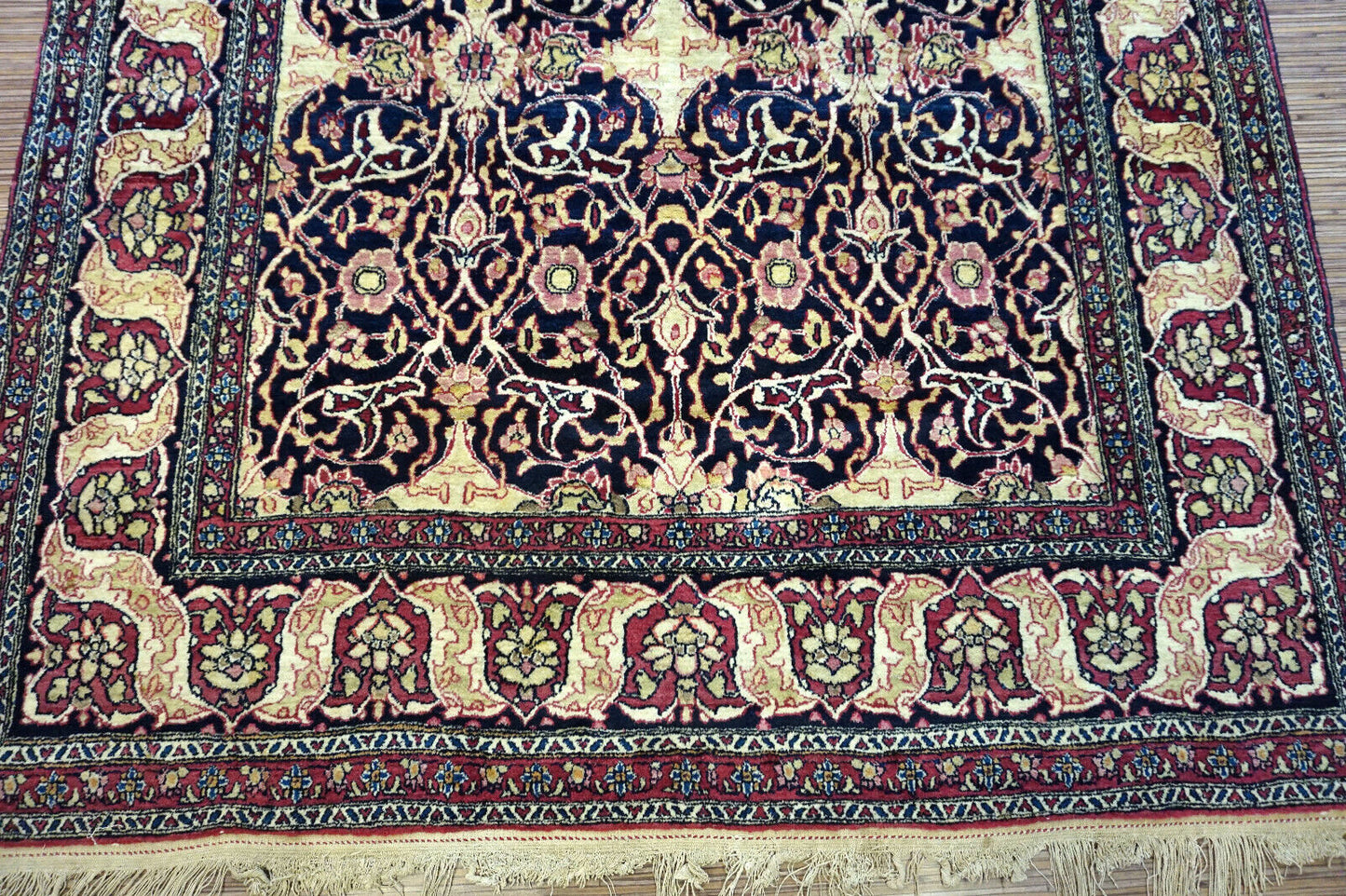 Handmade antique Persian Isfahan rug in unusual repeating design. The rug is from the beginning of 20th century in original good condition. It is made in wool.