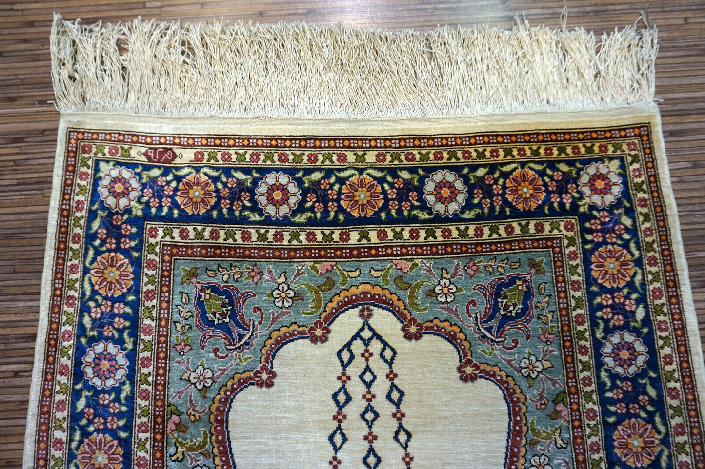 Handmade vintage Turkish Hereke silk prayer rug in beuge color. The rug is from the end of 20th century in original good condition.