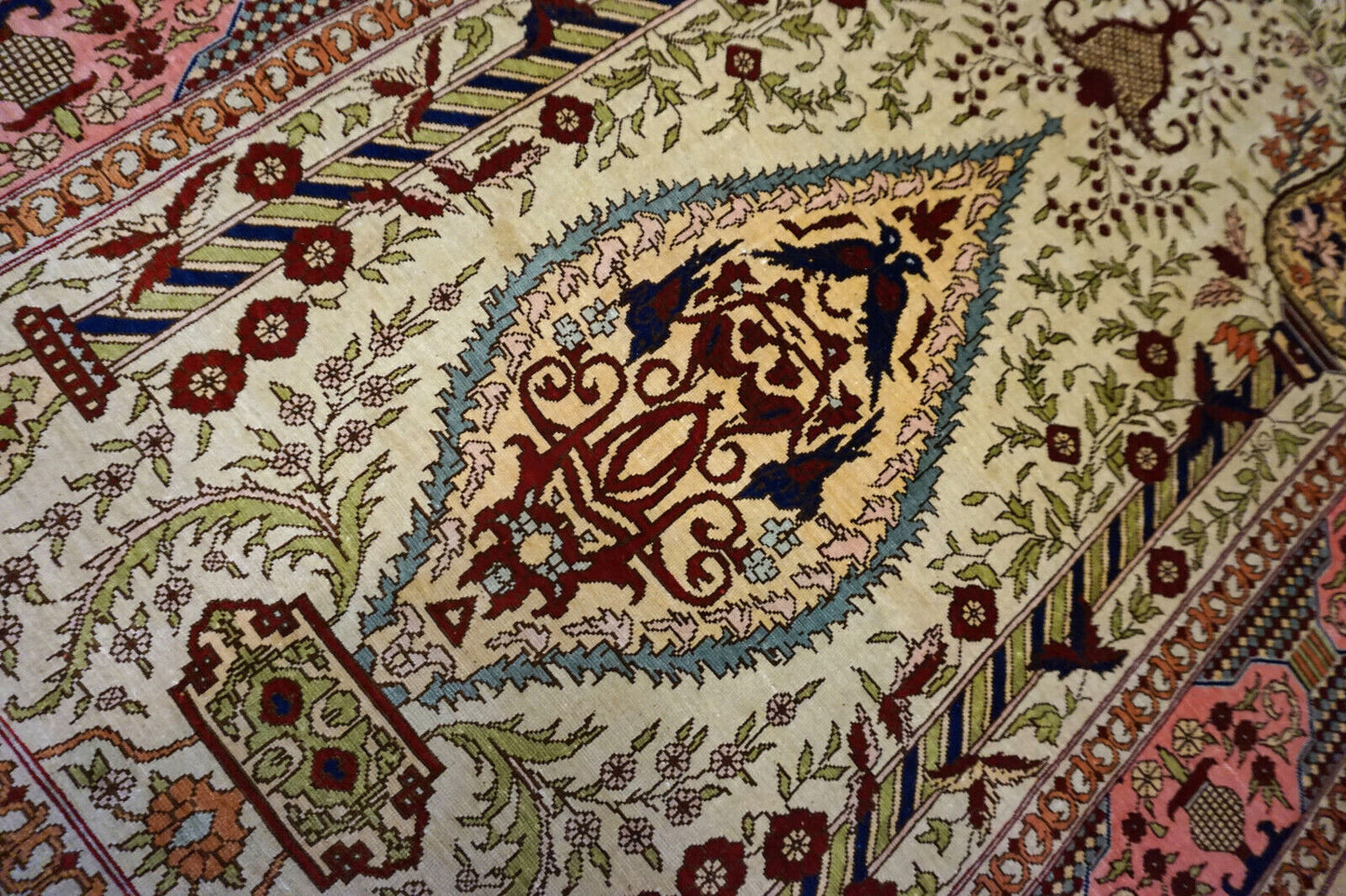 Handmade vintage Turkish Hereke silk prayer rug in beige, pink and blue colors. The rug is from the end of 20th century in original good condition. It is made in natural silk.