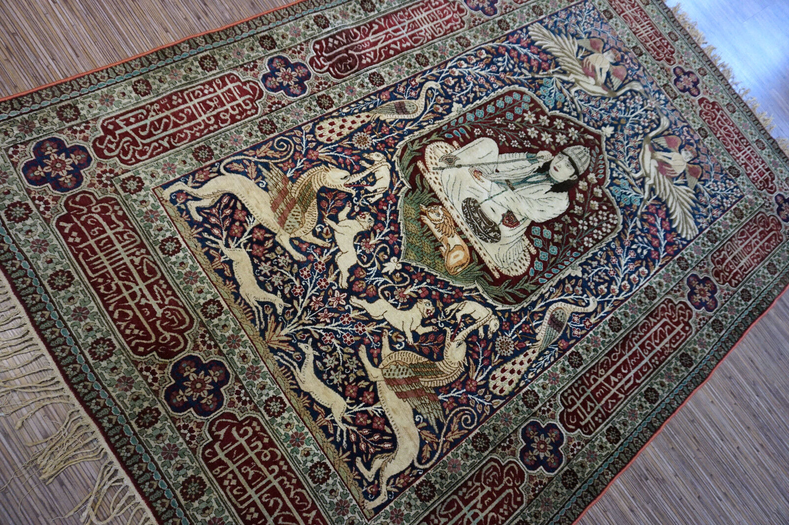 Handmade antique Persian Kerman Lavar rug with pictorial dsign. The rug is from the begining of 20th century in original good condition.