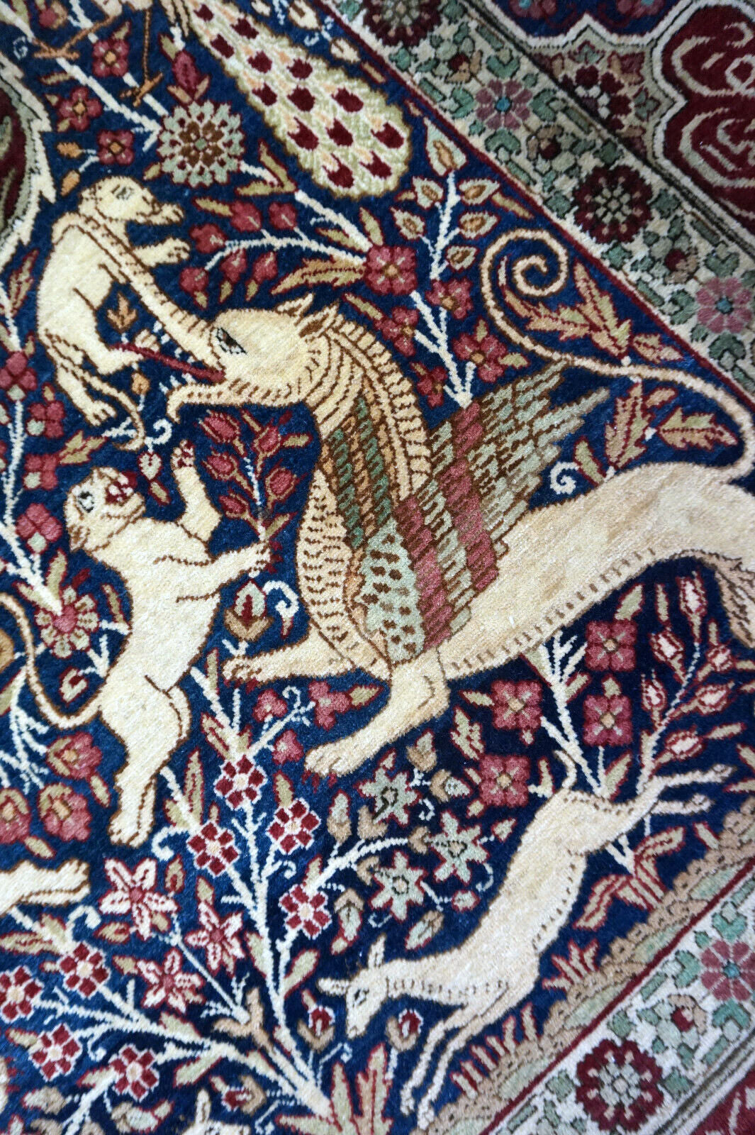 Handmade antique Persian Kerman Lavar rug with pictorial dsign. The rug is from the begining of 20th century in original good condition.