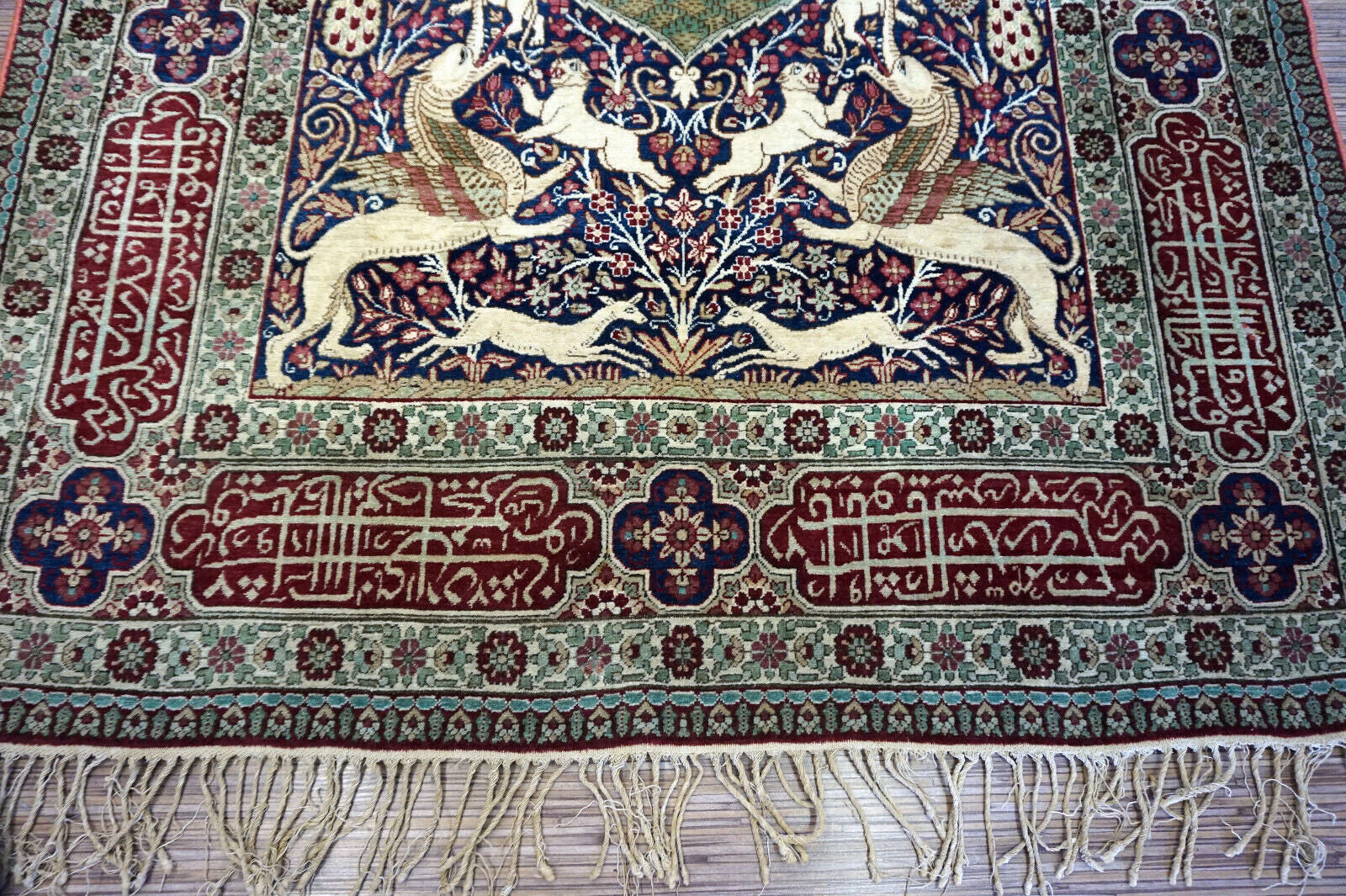 Handmade antique Persian Kerman Lavar rug with pictorial dsign. The rug is from the begining of 20th century in original good condition.