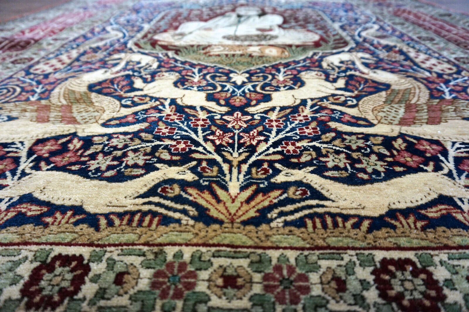 Handmade antique Persian Kerman Lavar rug with pictorial dsign. The rug is from the begining of 20th century in original good condition.
