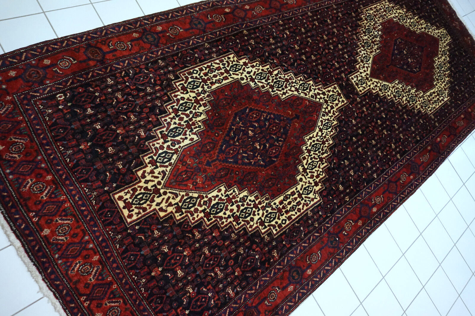 Handmade vintage Persian Senneh rug in kele size and traditional design. The rug is from the end of 20th century in original good condition.