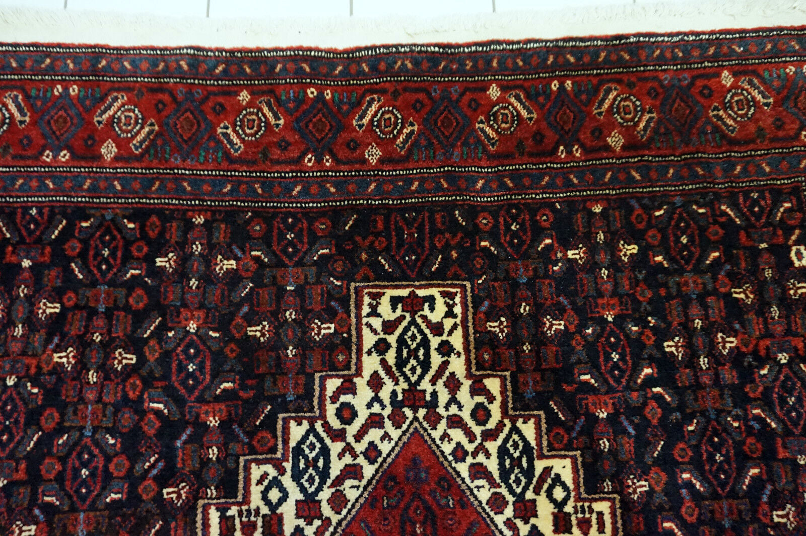 Handmade vintage Persian Senneh rug in kele size and traditional design. The rug is from the end of 20th century in original good condition.