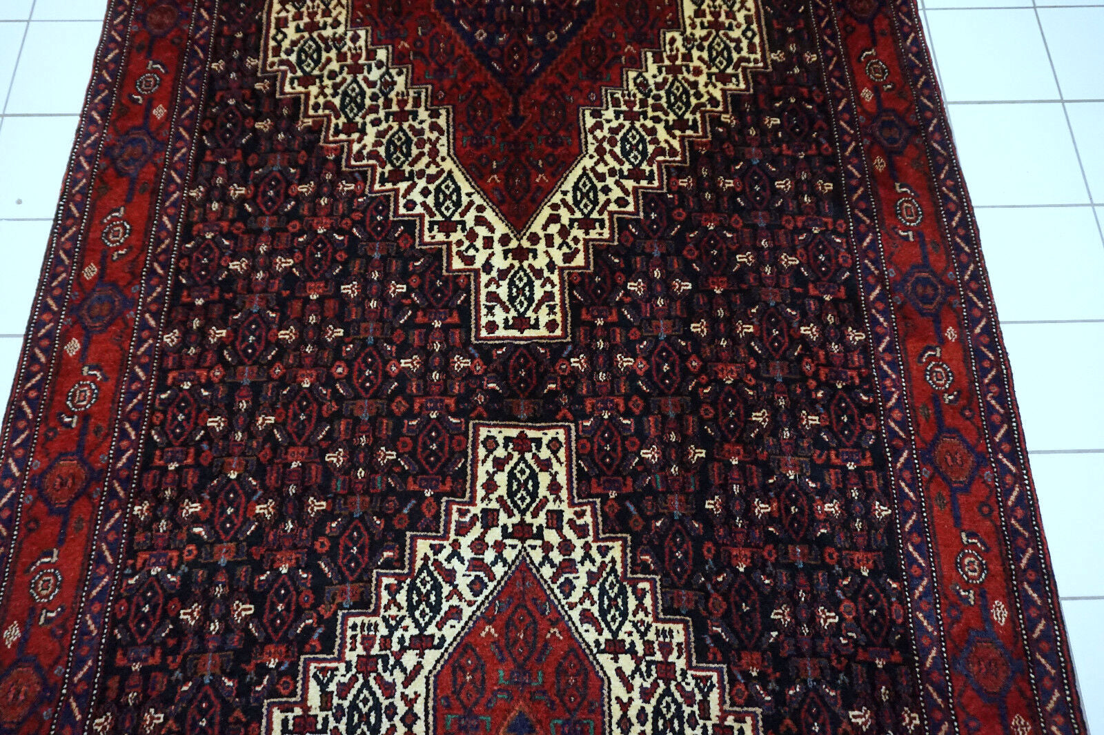 Handmade vintage Persian Senneh rug in kele size and traditional design. The rug is from the end of 20th century in original good condition.