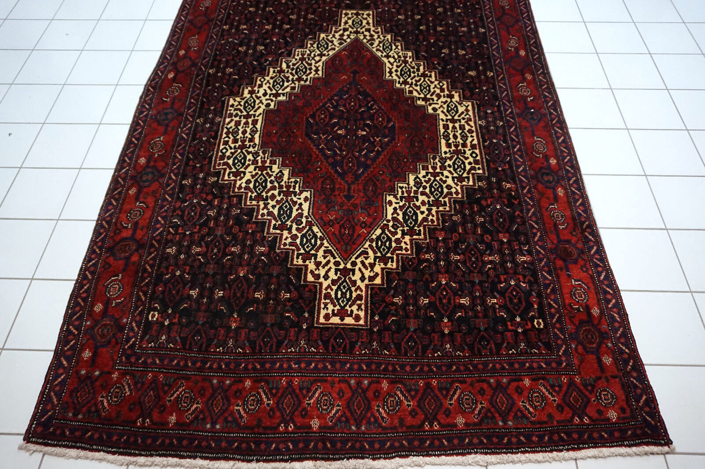 Handmade vintage Persian Senneh rug in kele size and traditional design. The rug is from the end of 20th century in original good condition.