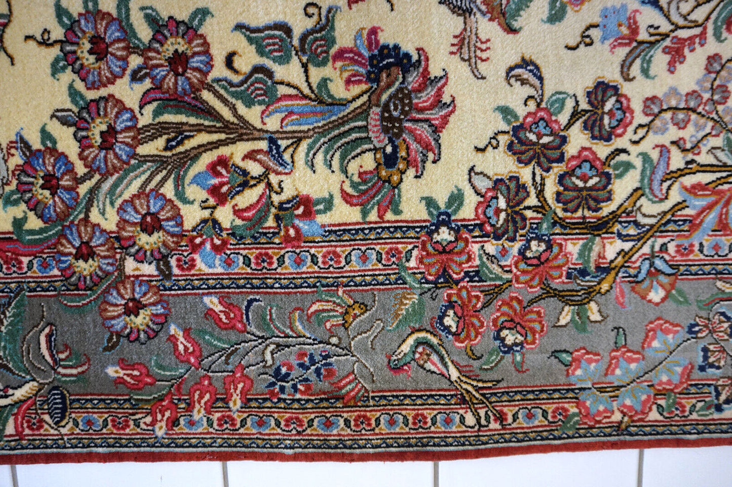 A corner of the vintage Qum rug showing the intricate weaving and detail.