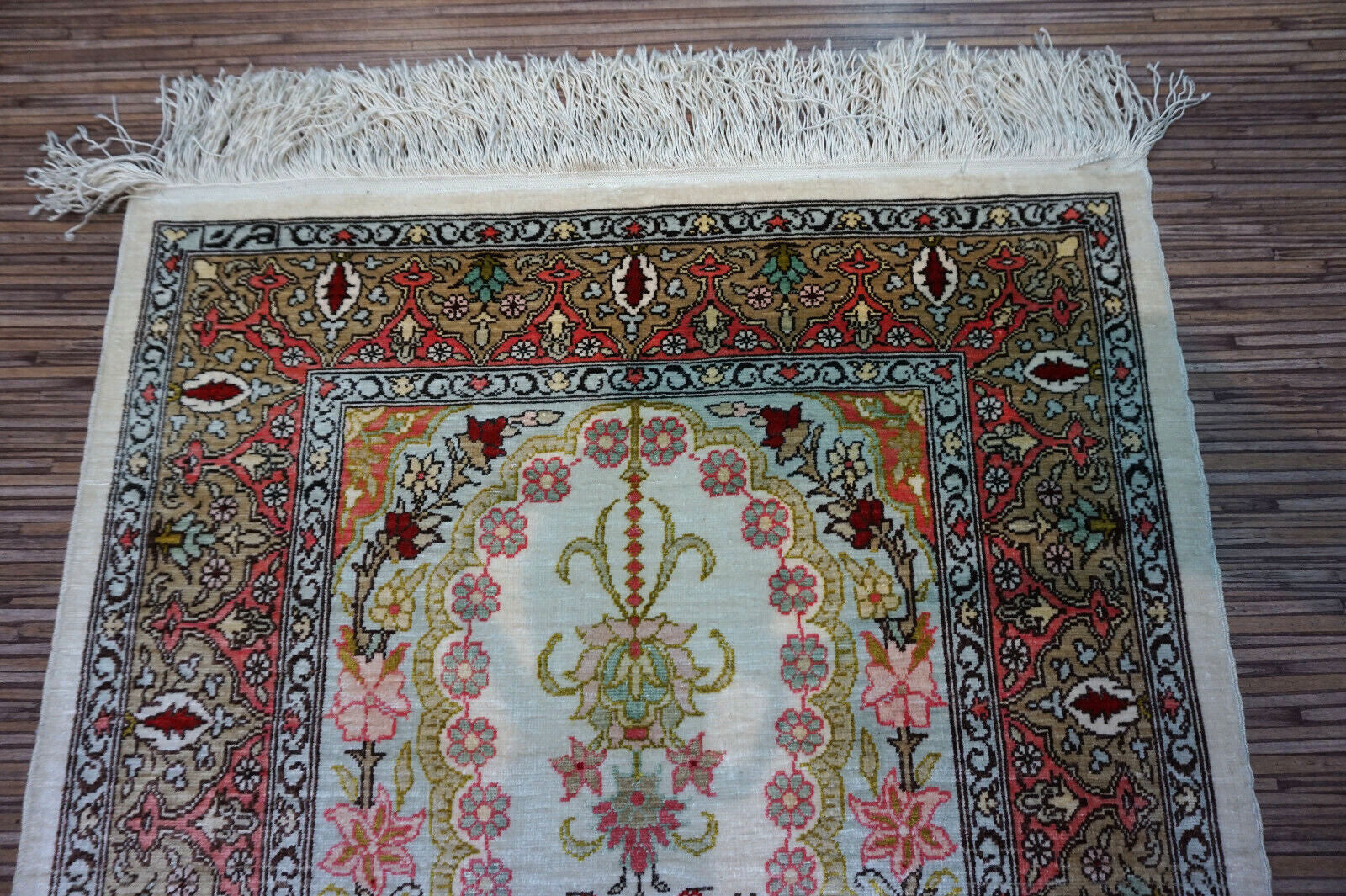 Close-up of prayer design on Handmade Vintage Turkish Hereke Silk Rug