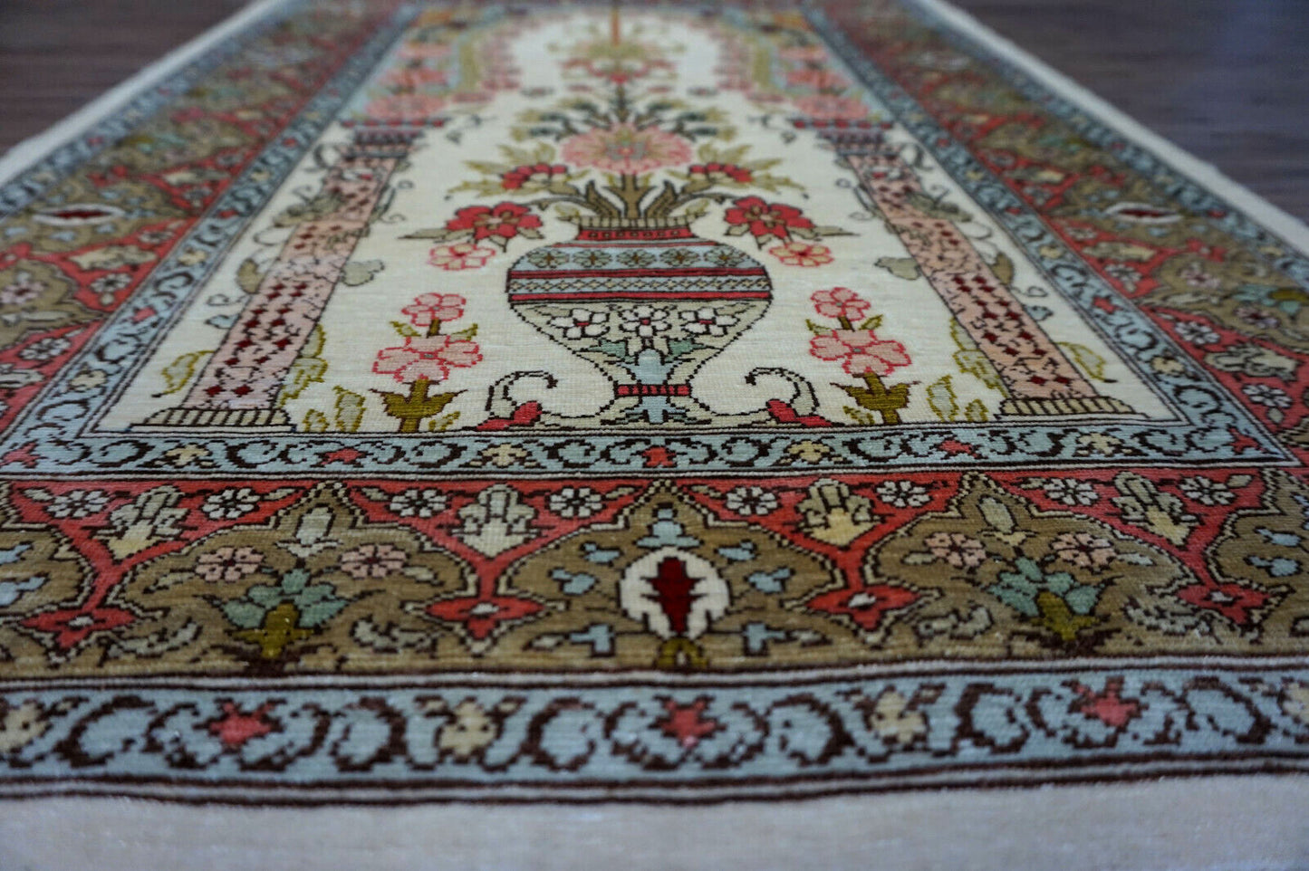 Vintage Hereke Rug with large vase centerpiece