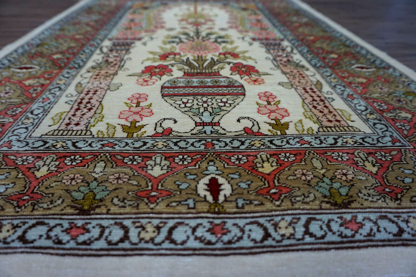 Vintage Hereke Rug with large vase centerpiece