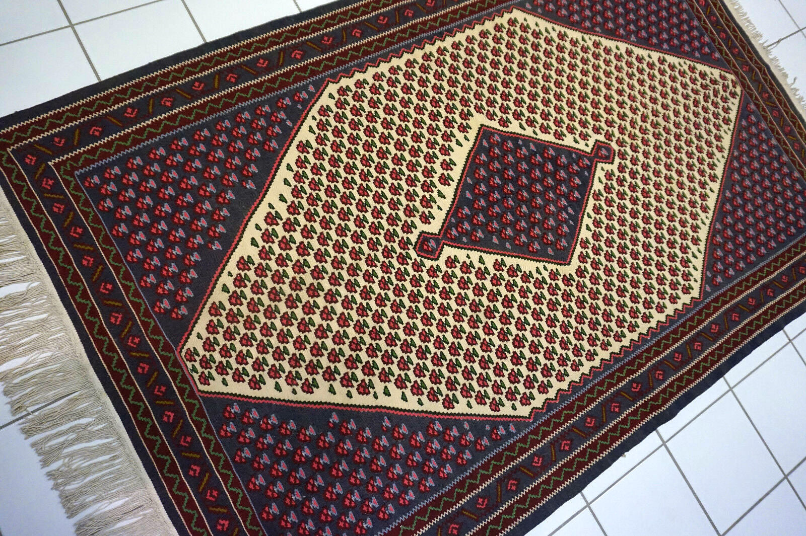 Close-up of the vintage 1970s kilim with its unique design and color palette