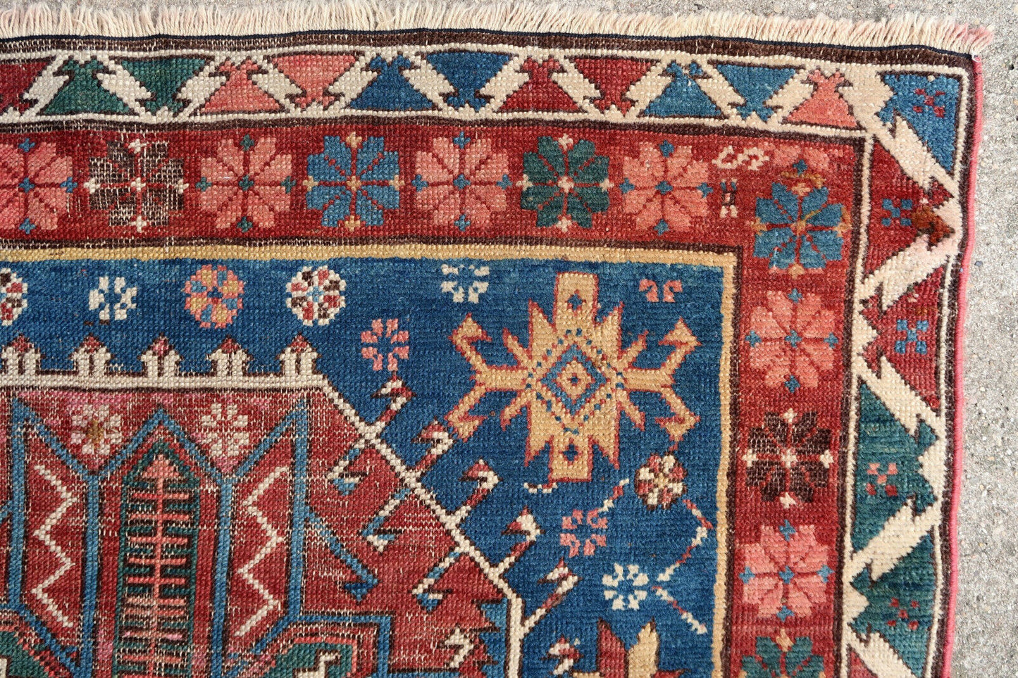 Handmade antique rug from Caucasian Shirvan region in blue and red colors. The rug has two different blues on the background. The rug is from the end of 19th century in distressed condition, it has some low pile and old restorations.