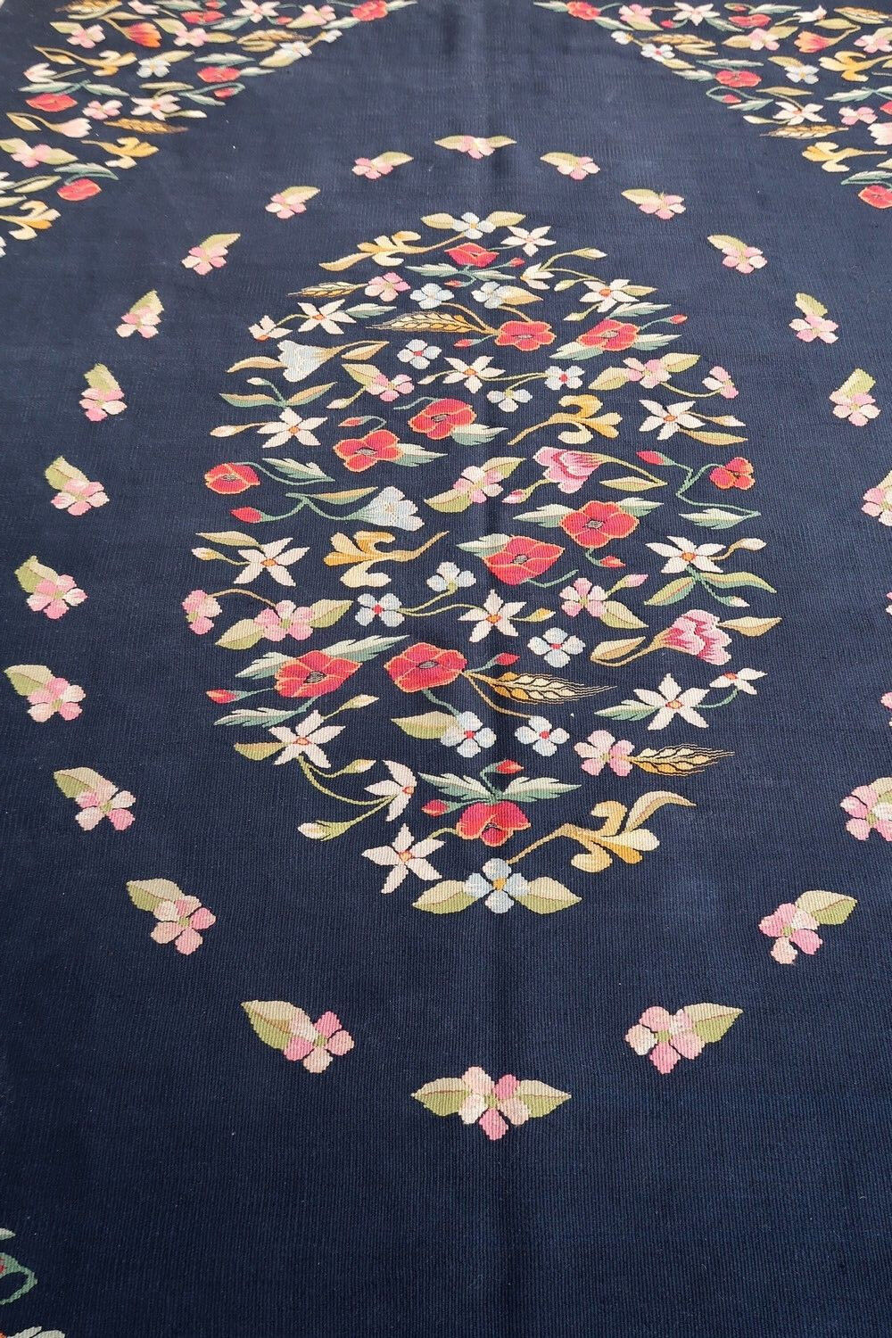 Handmade vintage kilim in black color and floral design from Romania. This Bessarabian rug is in original good condition, made in wool. The rug is from the middle of 20th century.