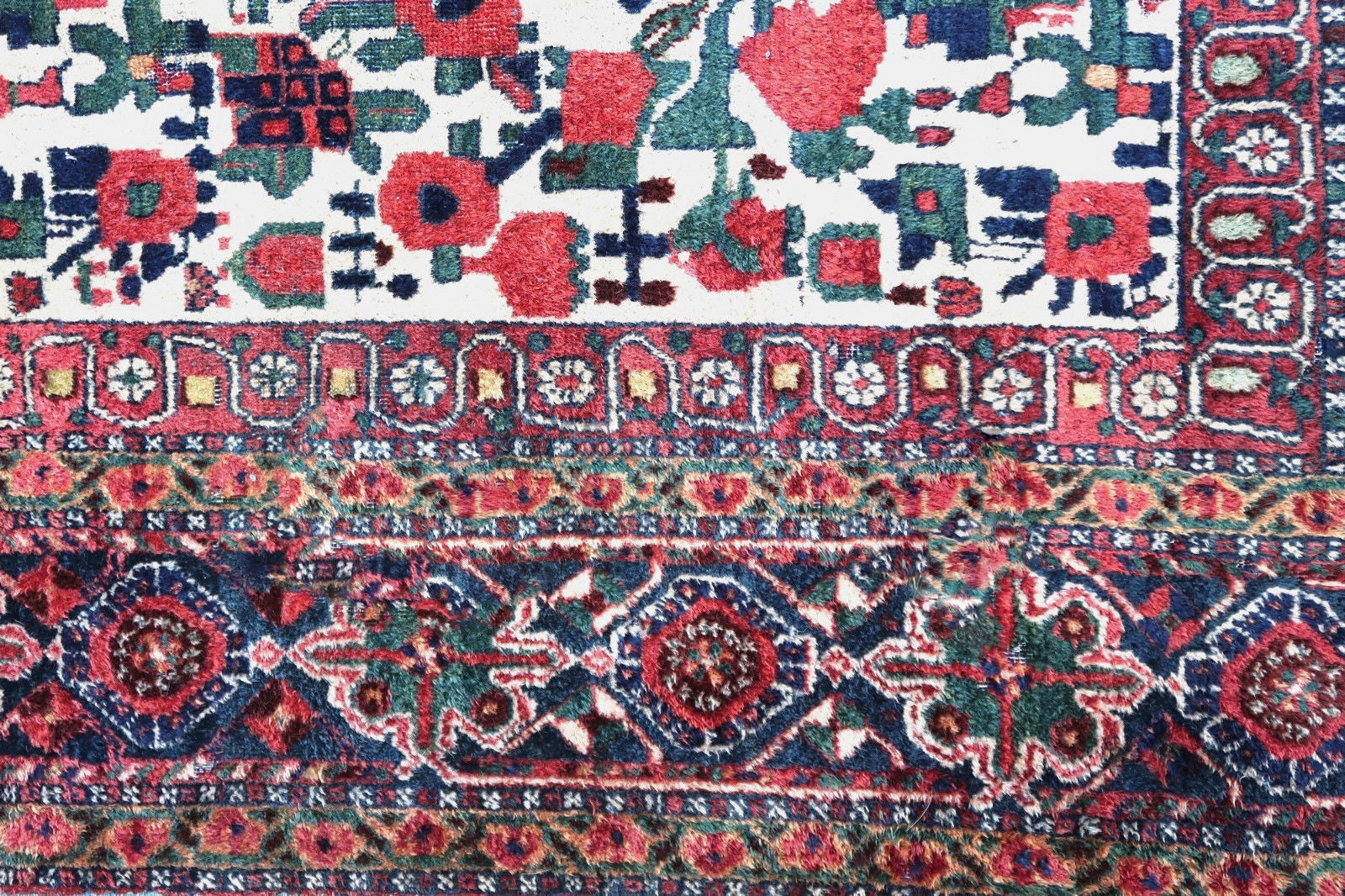 Handmade antique Persian Afshar rug in white color and all-over floral design. The rug is from the beginning of 20th century in original condition, the rug has low pile at some areas.