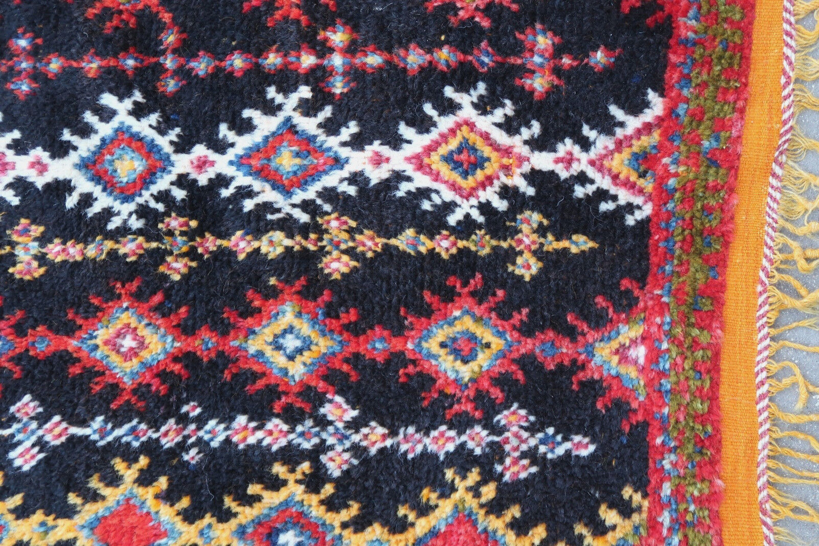 Handmade antique Moroccan Berber rug in tribal design. The rug is from the beginning of 20th century in original good condition.