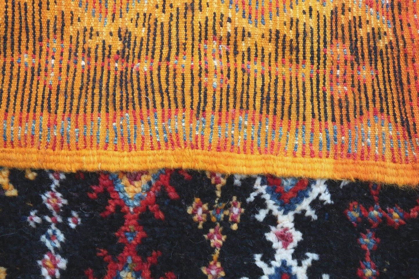 Handmade antique Moroccan Berber rug in tribal design. The rug is from the beginning of 20th century in original good condition.