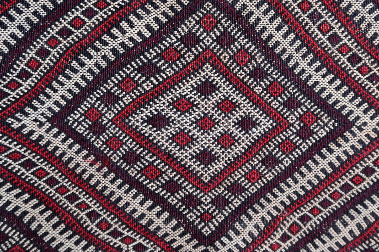 Handmade vintage Moroccan Berber kilim in geometric design and middle Atlas region. The rug is from the middle of 20th century in original good condition.
