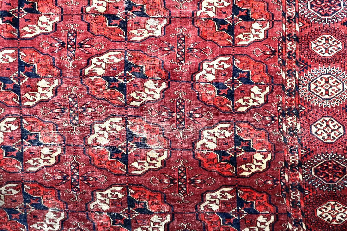 Handmade antique Turkmen Tekke rug in traditional design. The rug is from the end of 19th century in original condition, it has some low pile.