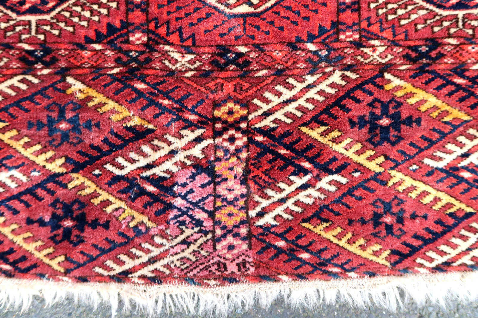 Handmade antique Turkmen Tekke rug in traditional design. The rug is from the end of 19th century in original condition, it has some low pile.